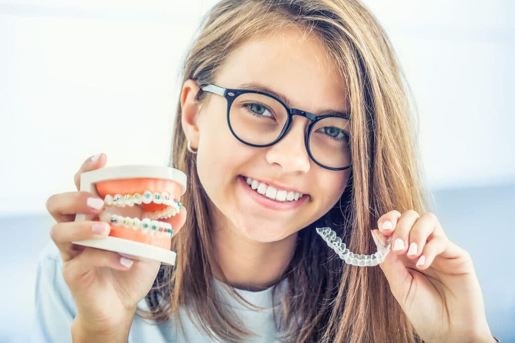Braces Vs Invisalign For Teens: What Parents Should Know Teen Comparing Braces And Invisalign Treatment Options